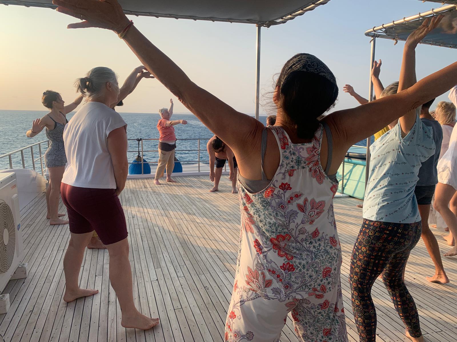 The group sounding and moving together on deck at sunset