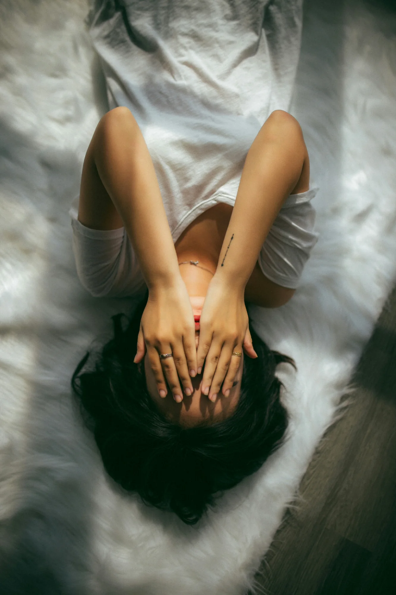 A woman resting with her hands gently over her face