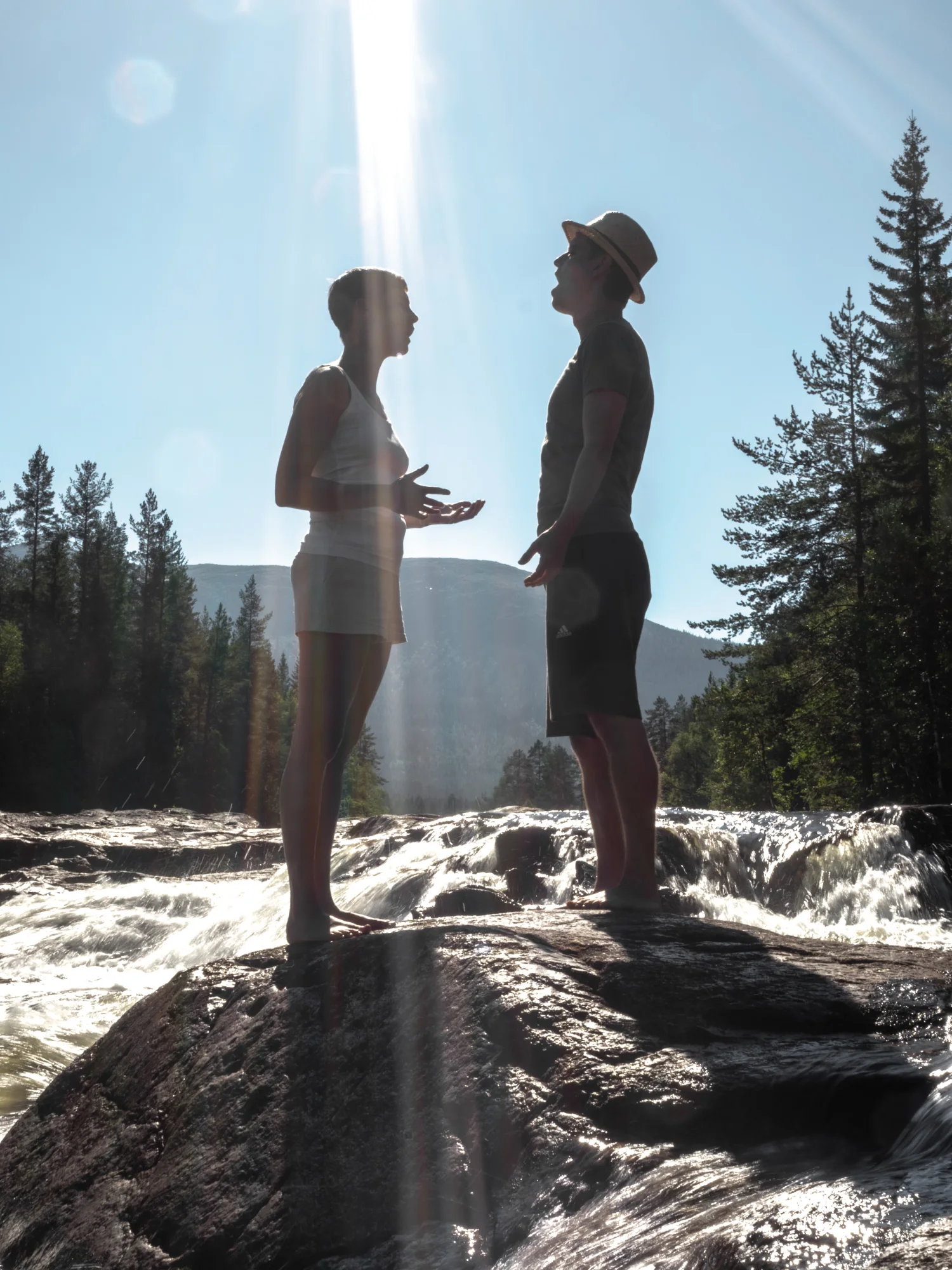 Jacob and Upala, facing one another by a river